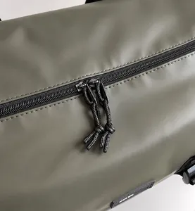 Macro view of smooth dual zippers and durable nylon fabric on travel duffle bag