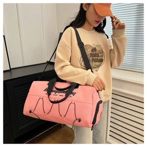 Pink fitness bag with dry-wet separation showing real-size carrying on shoulder