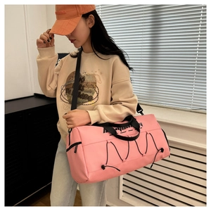 Pink waterproof fitness bag with adjustable shoulder straps and side drawstring details