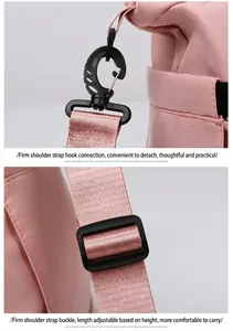 Detail of pink travel bag with black plastic swivel hooks and adjustable shoulder straps