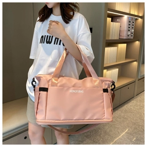 Detailed view of pink lightweight large capacity nylon travel bag with shoulder strap