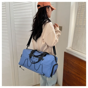 Blue waterproof sports bag with large capacity, durable handles and adjustable shoulder strap