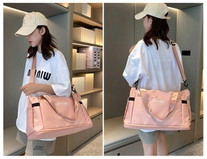Close-up of pink waterproof travel bag with adjustable strap and side pocket for gym use