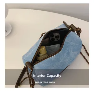 Internal capacity of light blue denim textured crossbody bag showing daily essentials