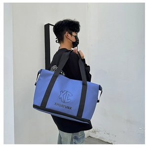 Detail view of large blue travel bag with separate bottom zipper compartment for shoes