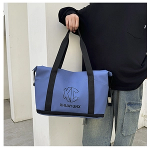 Detail of blue travel bag showing the bottom shoe compartment and double zipper structure