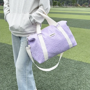 Detail of lavender purple bubble texture travel bag with Fashion Bag woven label
