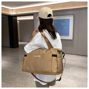 Detail view of khaki travel bag showing spacious compartments and dedicated shoe section
