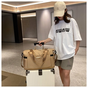 Detailed view of khaki travel bag showing sleeve attached to suitcase handle