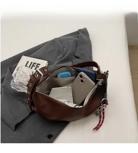 Detailed view of the spacious inner compartment of the brown leather hobo shoulder bag