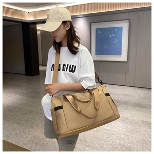 Detail showing khaki travel bag with wide straps and side pockets in a lifestyle setting