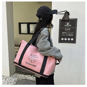 Detail of pink travel bag with separate shoe compartment and stylish XC branding