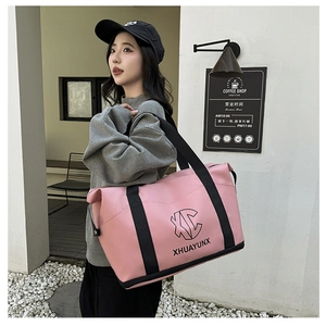 Pink PU leather travel bag detail showing metal buckles and stylish geometric brand logo