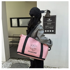Pink travel bag with a separate shoe compartment and reinforced black nylon straps
