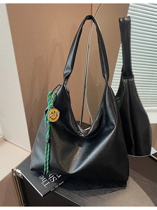Retro black leather tote bag with large capacity and a green smiley pendant accent