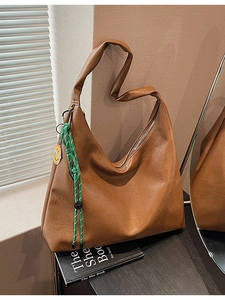 Brown large-capacity PU tote bag with a green woven rope and yellow smile pendant tag
