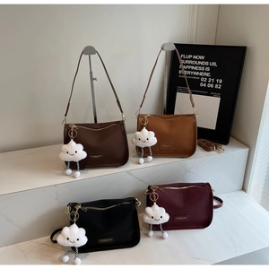 Detail view of stylish crossbody pillow bags in four colors with cute cloud pendants