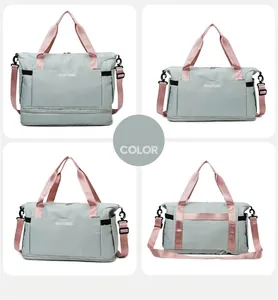 Detail view of large mint green travel duffel with pink straps and shoe compartment