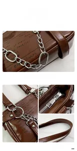 Detail view of brown glossy leather bag with vintage graffiti and silver chain strap