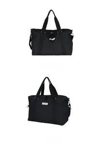 Detailed views of black quilted travel bag with fashion label and webbed handles