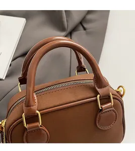 Gros plan détaillé du sac à main en cuir marron avec coutures et fermeture éclair