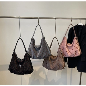 Detailed display of plush polka dot hobo tote bags featuring elegant bow decorations