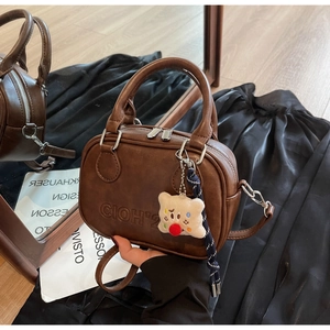 Sac Boston vintage en cuir marron avec breloque ours et bandoulière réglable