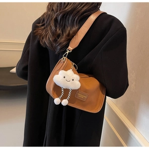 Brown leather shoulder bag with a cloud charm and embossed fashion leather label