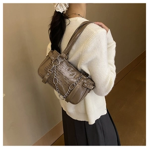 Detail of dark khaki patent leather shoulder bag with chain and typography print