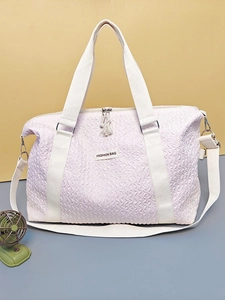 Light purple travel bag with textured fabric and ivory handles for sport and gym