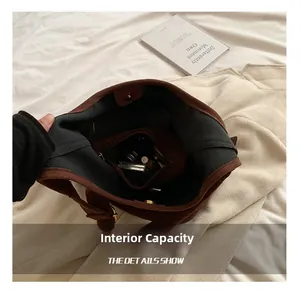 Internal capacity of brown frosted leather tote bag showing pockets and magnetic closure