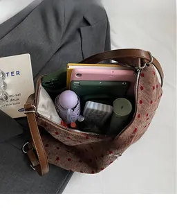 Macro view of a brown polka dot tote bag showing spacious interior for daily essentials