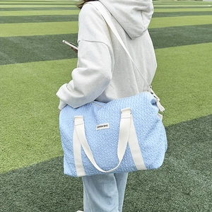 Light blue bubble texture travel bag with adjustable strap and top handles