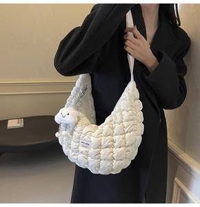 Détail du sac matelassé blanc avec pendentif nuage en peluche et étiquette Mulaidi