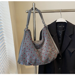 Detailed texture of grey polka dot tote bag with metallic bow and woven fabric finish