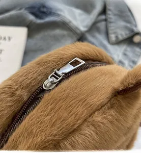 Close-up of smooth silver metal zipper on the brown plush capybara shoulder bag