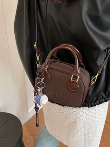 Retro dark brown mini crossbody bag with embossed logo and sports charm detail