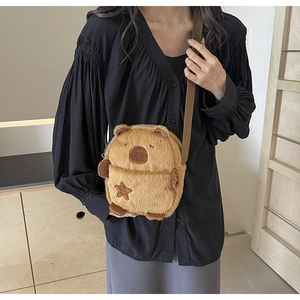 Detail of Capybara plush bag featuring adjustable strap and star-shaped embroidery