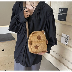 Detail of cute plush capybara crossbody bag featuring soft fur and star embroidery