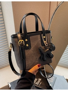 Vintage dark gray bucket bag with geometric patterns, gold hardware and dog charm