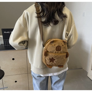 Detail of cute Capybara plush crossbody bag featuring soft fur and star embroidery