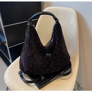 Polka dot backpack detail with silver bow charm on black velvet material