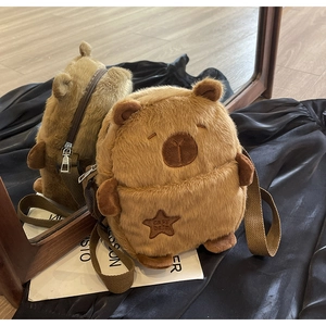 Detailed mirror shot of a fluffy brown plush bear crossbody bag with embroidery