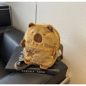 Close-up of brown capybara plush bag featuring soft faux fur and star embroidery detail