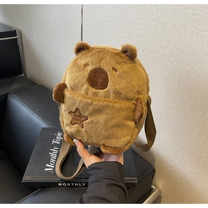 Detailed close-up of brown capybara plush crossbody bag with star embroidery on soft fur