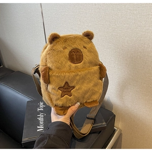Close-up of soft plush capybara bag with embroidered star and adjustable strap