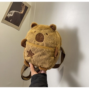 Detailed close-up of brown plush capybara crossbody bag with star embroidery and soft texture