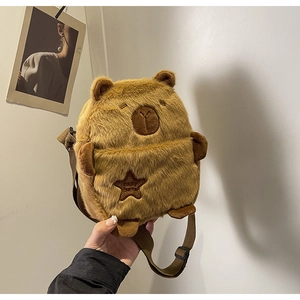 Detail of cute brown plush Capybara crossbody bag featuring a soft star patch and adjustable strap