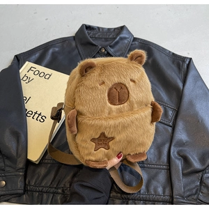 Detail of plush Capybara crossbody bag featuring a soft texture and star embroidery