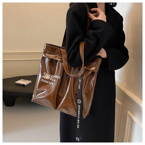 Caramel brown tote bag with stylish shoulder straps shown on model for daily commuting